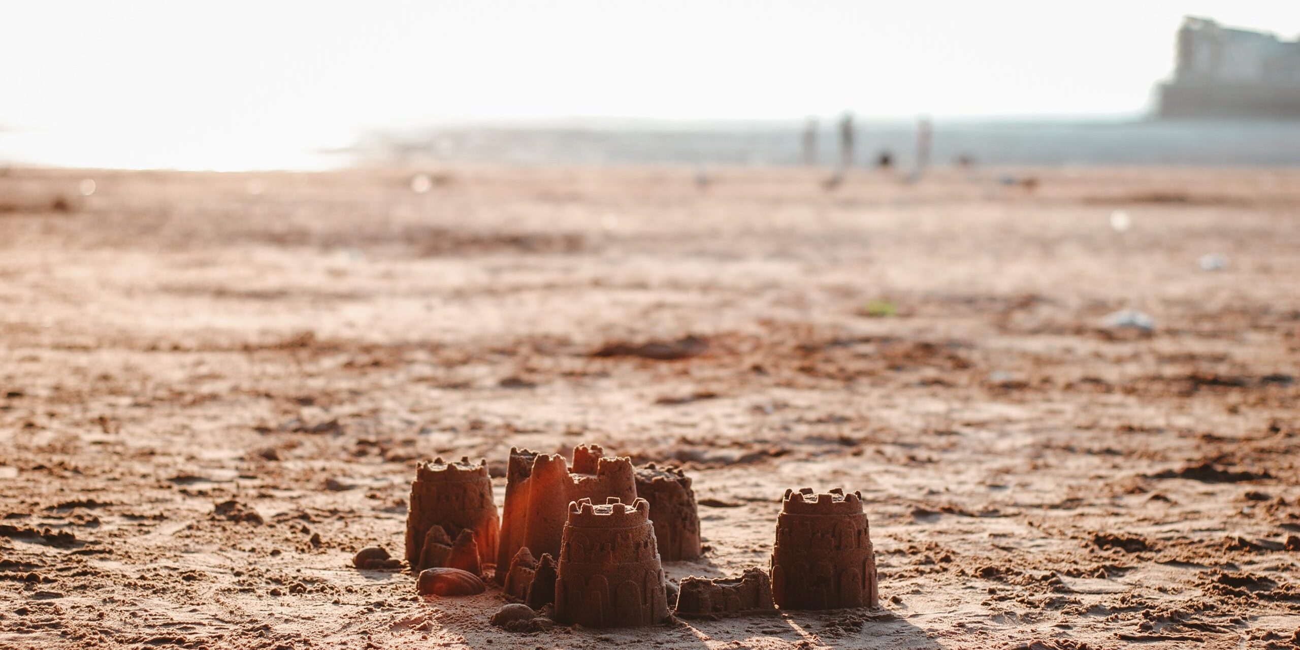 sand castle under white sky at daytime