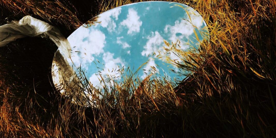 round mirror on grass